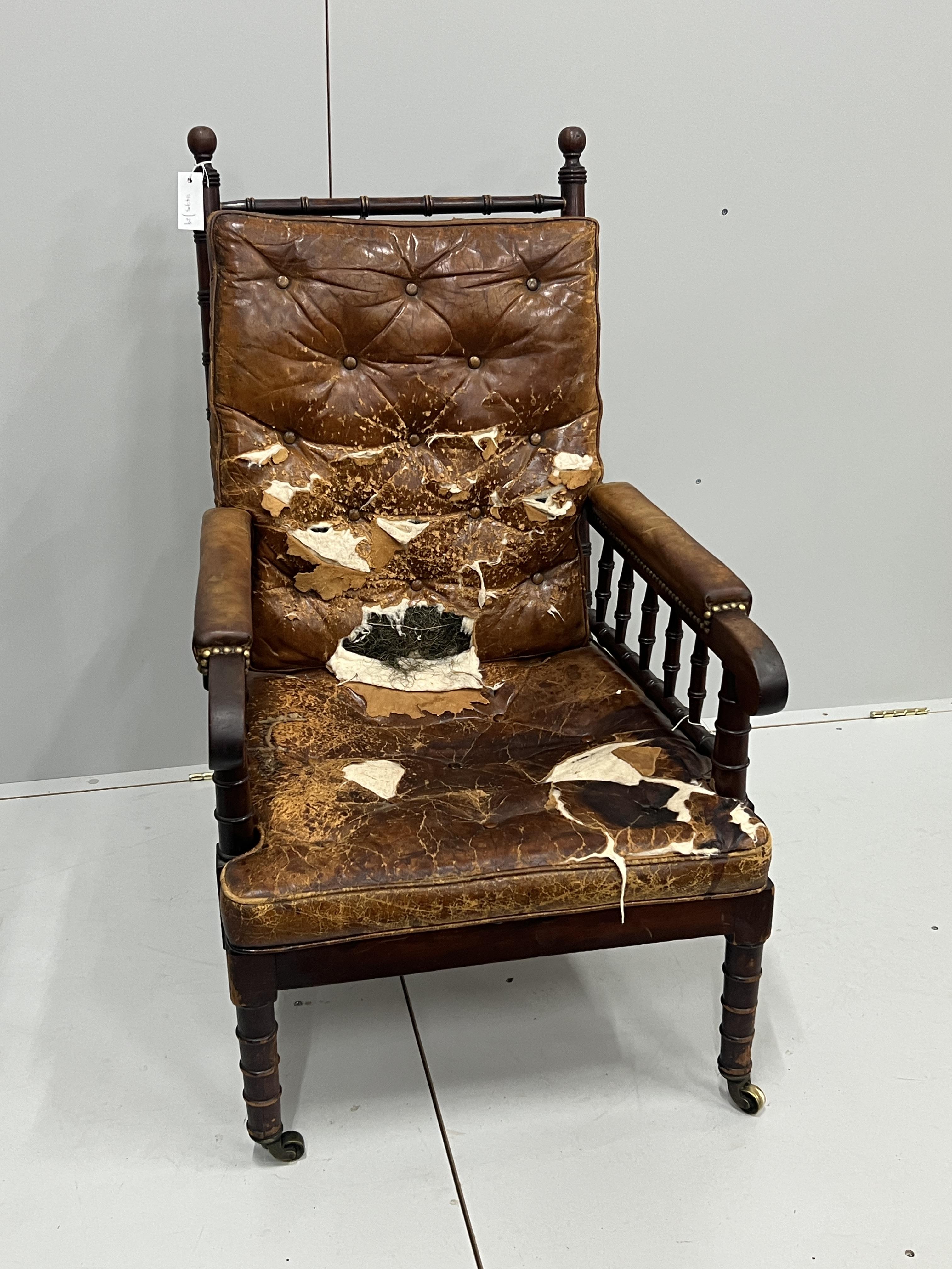 An early Victorian turned mahogany library chair with distressed leather cushion seat and back, width 62cm, depth 66cm, height 104cm